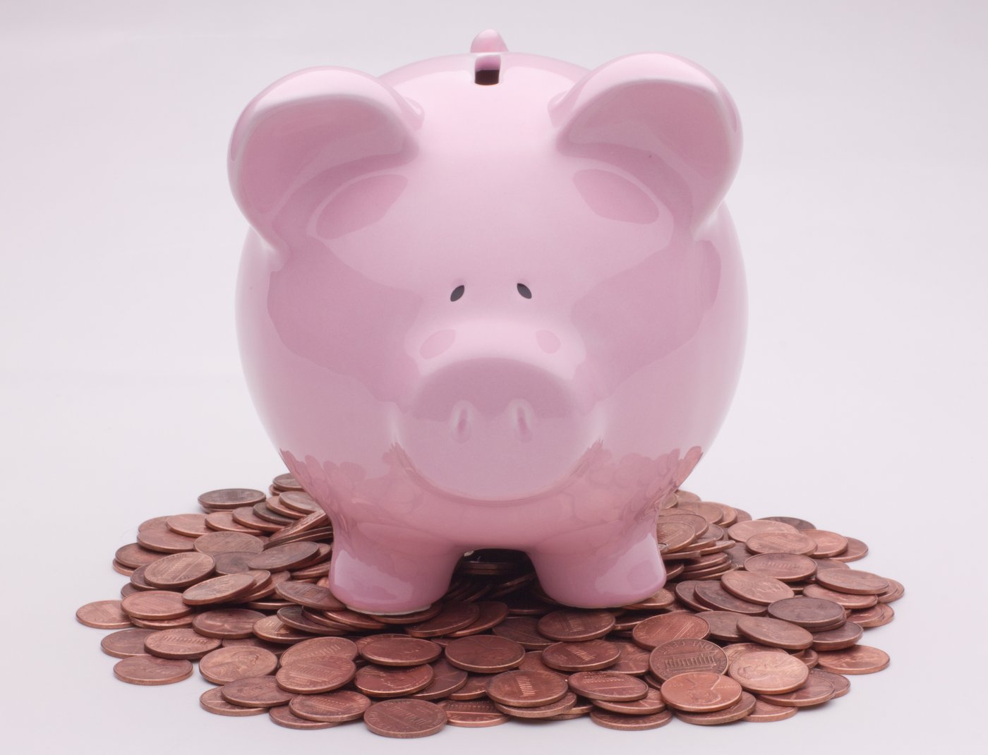Piggy bank on coins, symbol of small savings