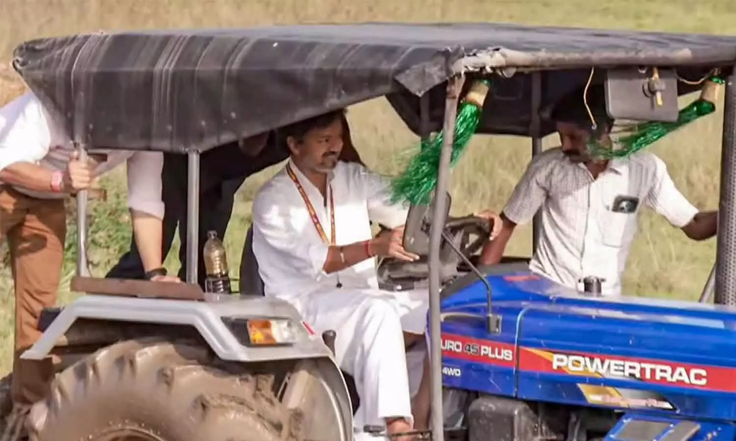 A farmer driving a tractor in a field