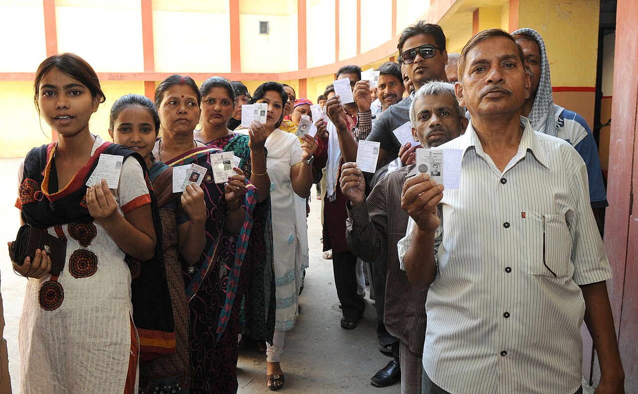 Voters queue at a polling booth in India